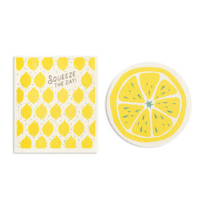 Two yellow and white biodegradable dish cloths. One is round and looks like a sliced lemon and the other is yellow illustrated lemons and the saying "Squeeze the day".