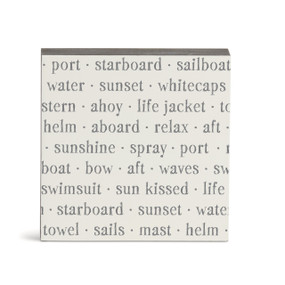 A white square wall art with words about sailing on it.
