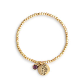 A gold beaded bracelet with a iris flower round charm and violet colored stone.