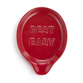 A red ceramic spoon rest that says "Rest Easy".