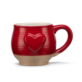A red ceramic mug with a tan textured base and a raised red heart on the front.
