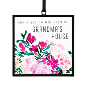 A small square shaped sun catcher with illustrated pink flowers and the saying "there are no bad days at Grandma's House".