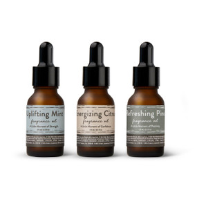 A set of three different essential oils in, mint, citrus and pine.
