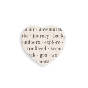 A set of four heart shaped white ceramic coasters with words about hiking on it.