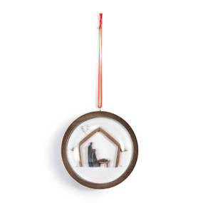 A hanging glass dome ornament on a wood base. The inside has a pebble image of the nativity scene.