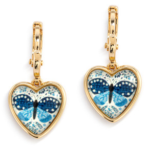 A pair of gold dangling earrings with a heart shaped charm and an illustrated blue butterfly inside.