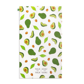 A white kitchen towel with illustrations of ingredients for guacamole and the saying "Talk the Talk Guac the Guac".
