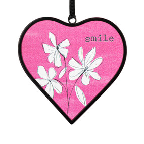 A small pink heart shaped sun catcher with floral illustrations and the word "smile".