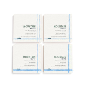 A set of four white square coasters with a basic recipe for a Mountain Mojito written in blue.