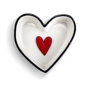 Top down view of a white and black heart shaped dish with a raised red heart on the inside.