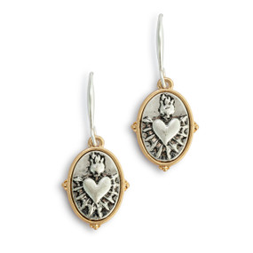 Silver oval sacred heart earrings with a gold border.