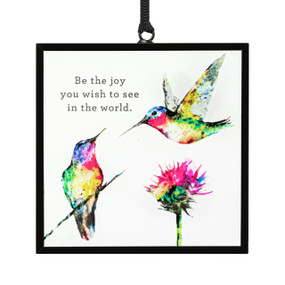 A square suncatcher with two watercolor hummingbirds, a flower and the saying "Be the joy you wish to see in the world".
