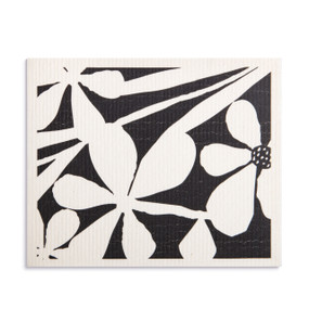 An oversized white and black biodegradable dish cloth with a bold floral design.