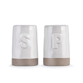 A set of two white ceramic salt and pepper shakers with tan textured bases. One has a S and the other has a P on it.