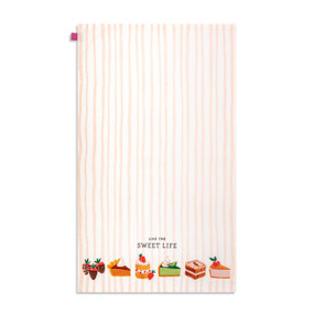 A white and tan vertically striped kitchen towel with colorful illustrations of desserts at the bottom and the saying "Live The Sweet Life".