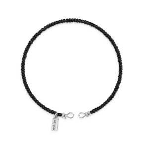 A round bracelet made of small black beads.