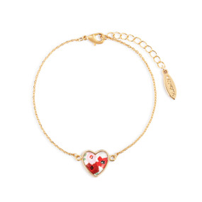 An adjustable gold chain bracelet with a heart shaped charm with red and pink flowers.