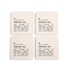 A set of four white ceramic coasters with the saying "RE: Out of Office Seeking Peace + Calm" with a short write up about someone seeking calm.
