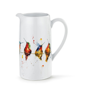 A white ceramic handled pitcher with a watercolor image of different hummingbirds on a wire around the pitcher.