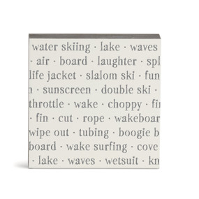 A white square wall art with words about water sports on it.