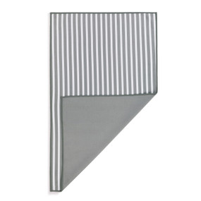A rectangular gray and white double sided towel, displayed with the striped side up and the gray back turned over at one corner.