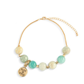 An adjustable gold chain bracelet with 7 turquoise and cream beads. There is a round gold charm that says "Believe Achieve" that can move between the seven beads.
