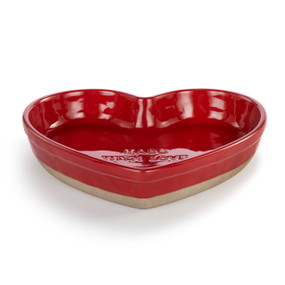 A heart shaped red ceramic baking dish with a tan textured base. It says "Made With Love" inside.