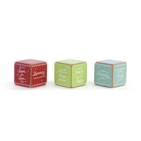 A set of three painted wood dice with instructions on them to make a game of happy hour and serving holiday drinks.