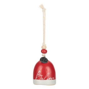 A mini red and white bell with the word "Believe" on the front. There are beads and a metal token at the top of the bell.