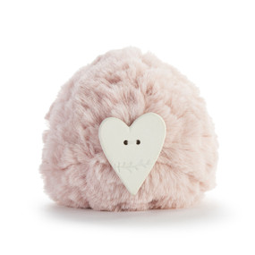 A round light pink pouf with a heart shaped diffuser attached.