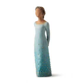 Front/left view: Darker-skin figure, arms clasped behind back, hair and deep blue ombré garment dotted with gold leaf