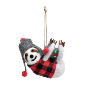 A felt ornament of a sloth dressed in a red and plaid vest and gray hat holding a present.