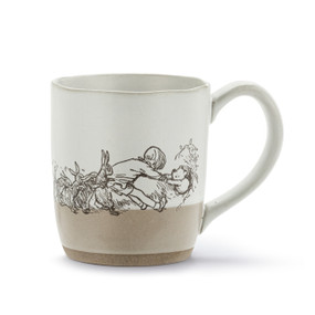 A white and tan ceramic mug with an illustration of Christopher Robin and friends pulling Pooh out of a hole.