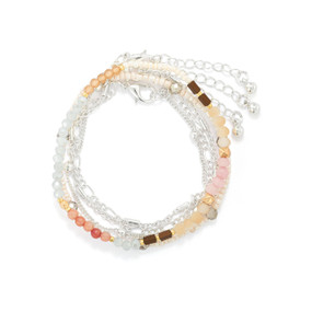 A multi-strand bracelet made with beads and silver chain. The beads are primarily in shades of silver and tan.