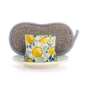 A cream ceramic soap dish with yellow lemons and green leaf pattern, and a gray sponge in the open slot.