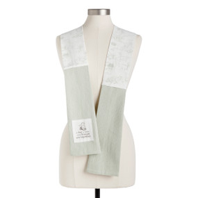 A white hundred acre wood fabric kitchen boa with light green towel ends and a fabric patch with the saying "A day is better when friends are together", displayed on a mannequin.