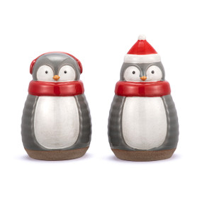 Two gray and white penguin shaped salt and pepper shakers. Each has a red scarf and either a stocking cap or earmuffs.
