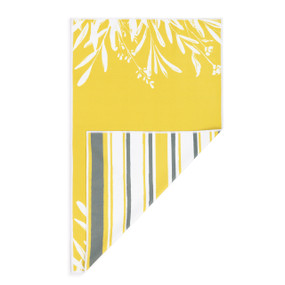 A rectangular double sided towel. One side is yellow with a white leaf pattern and the other is white with yellow and gray stripes, displayed with the white corner turned back.