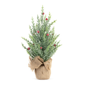 A frosted artificial evergreen tree with red berries in a burlap bag.