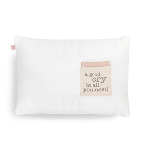 A white rectangular pillow with a cream fabric pocket on the front with the saying "a good cry is all you need". The pocket has a pink fabric folded in it.