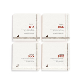 A set of four white square coasters with a basic recipe for a Vodka Buck written in red.