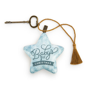 A light blue star shaped sculpture with snowflakes and the saying "Baby's 1st Christmas". The star has a gold tassel and gold key attached.