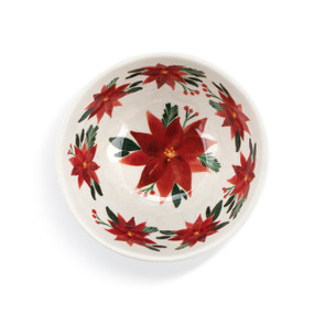 Top down view of a white and red dip bowl with a red poinsettia pattern inside.