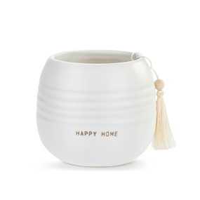 A small round white ceramic cachepot with "Happy Home" on the front with a cream tassel.