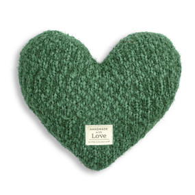 A green heart shaped pillow with a Giving Collection fabric patch at the bottom.