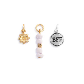 A set of three different gold and silver charms about friendship.