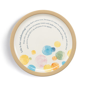 A round cream stoneware plate with a tan rim and large pastel dots at the bottom. The plate says "Life is for celebrating" and has a special message about celebrating and sharing.
