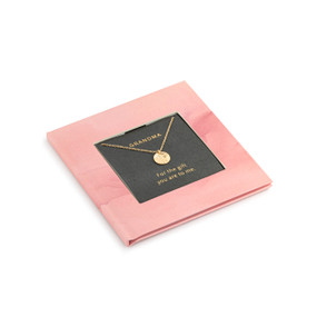 A small square pink book with inspirational content about grandmas. There is a gold chain necklace inside with a round charm.