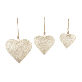 Three different sized heart shaped ornaments decorated with silver glitter and hung from brown twine hangers.