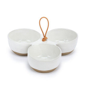 A white ceramic tri bowl with a tan textured base and a brown handle in the middle.